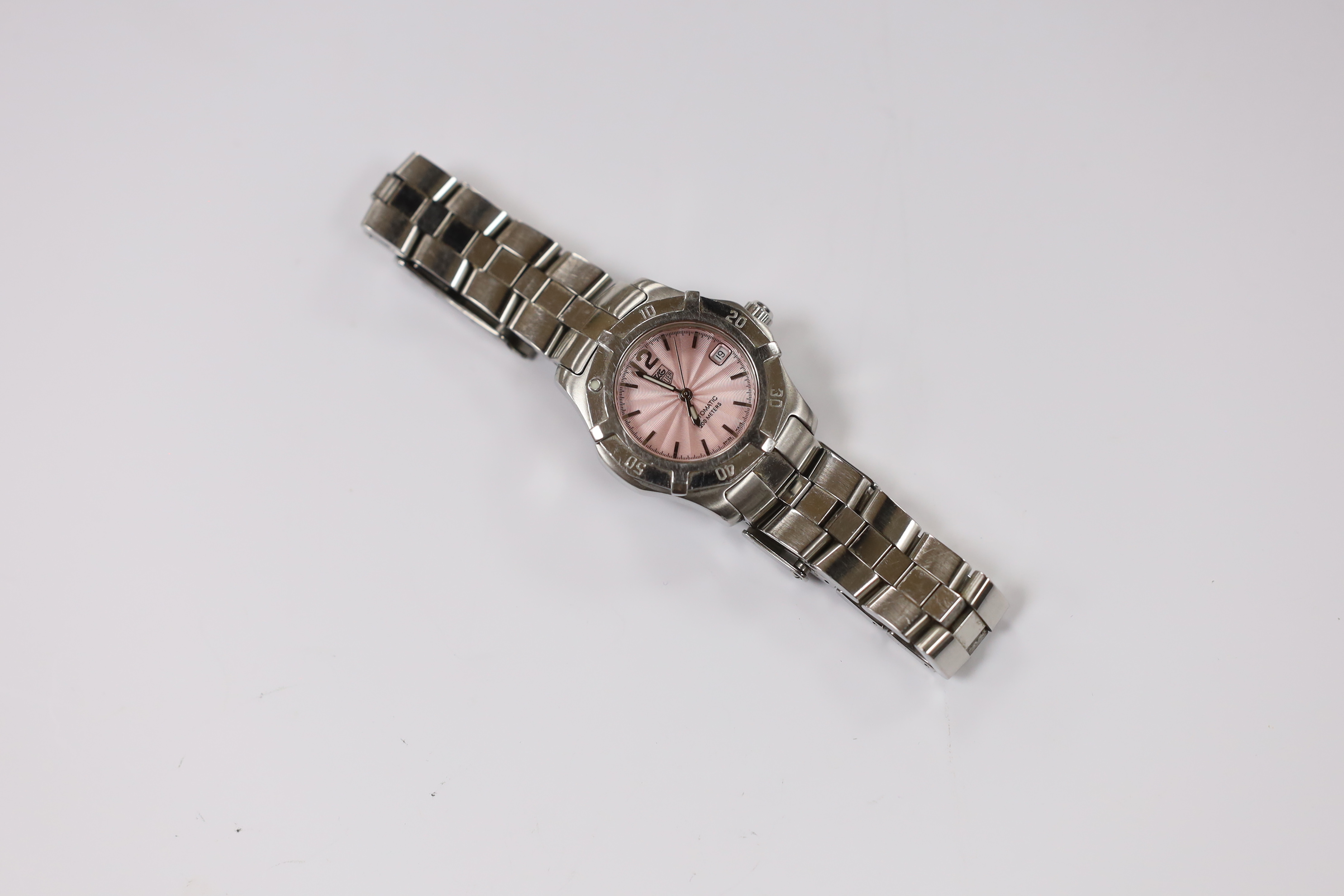 A lady's modern stainless steel Tag Heuer automatic wrist watch, with pink dial, on a Tag Heuer stainless steel bracelet.